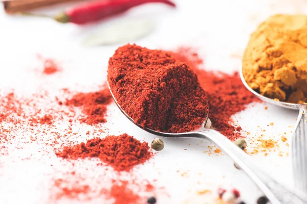 Spoons with paprika and curry — Stock Photo