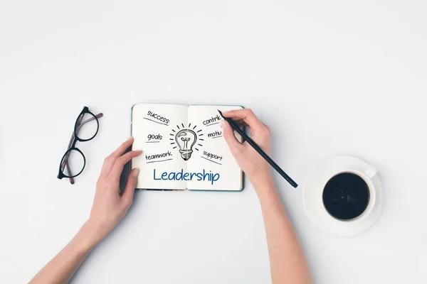 Writing leadership ideas in notebook — Stock Photo