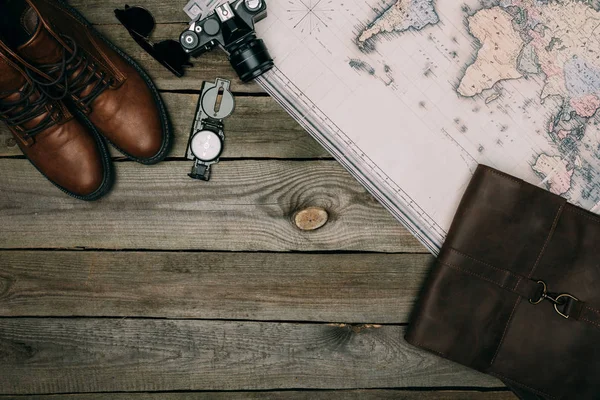 Map with film camera and compass with shoes — Stock Photo