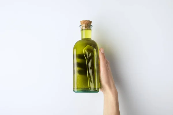 Woman holding bottle of olive oil — Stock Photo