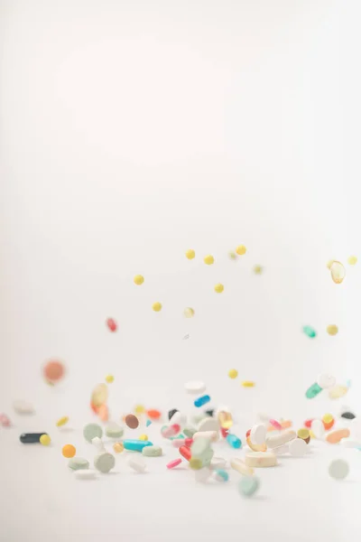 Colored pills spilling on surface — Stock Photo