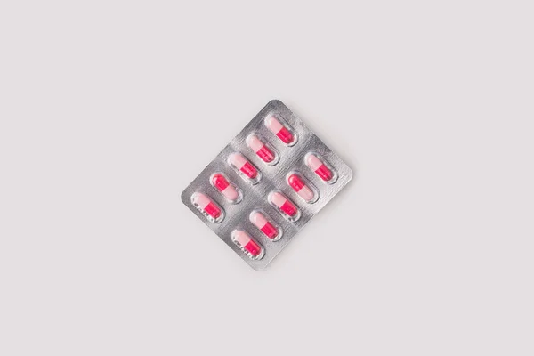 Blister pack with red and pink pills — Stock Photo