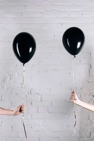 Women holding black balloons — Stock Photo