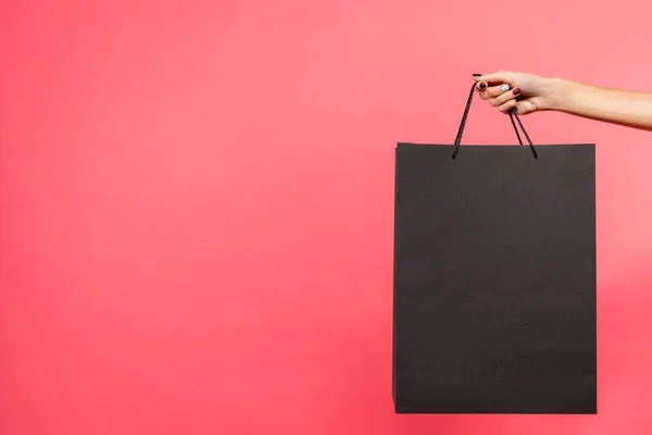 Woman holding black shopping bag — Stock Photo