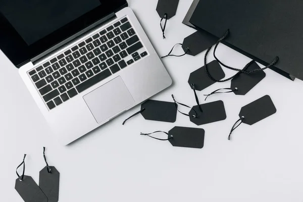 Laptop and black price tags — Stock Photo