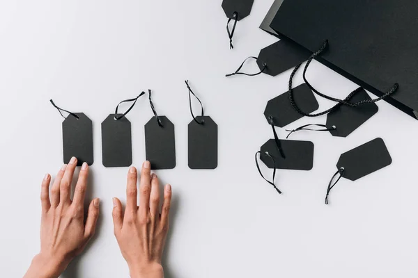 Female hands and blank labels — Stock Photo