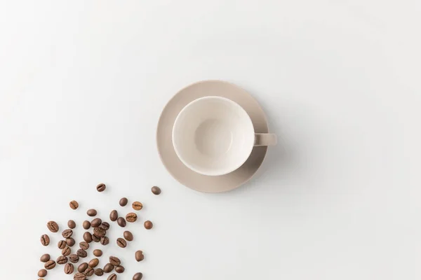 Cup with coffee beans — Stock Photo