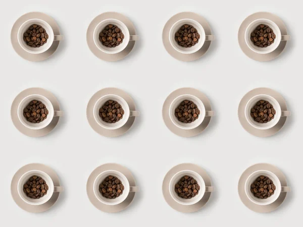 Pattern of cups with coffee beans — Stock Photo