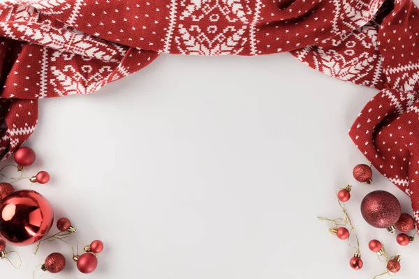 Christmas balls and winter scarf — Stock Photo