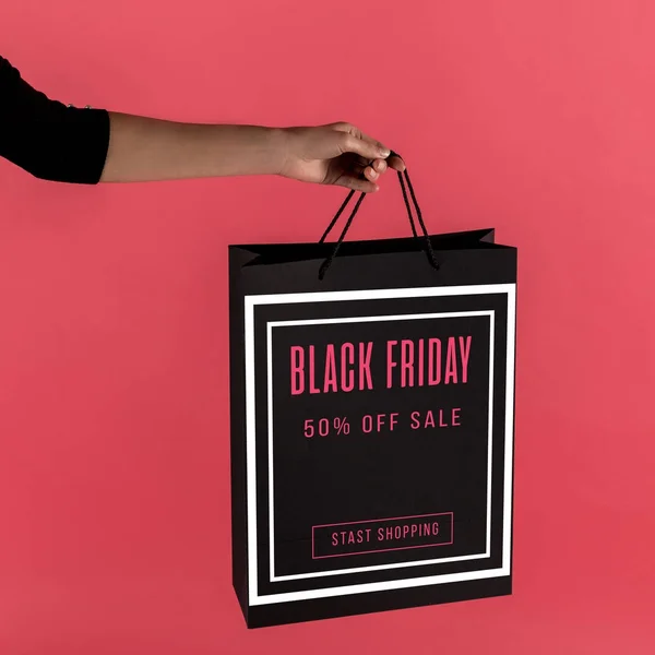 Woman holding black shopping bag — Stock Photo