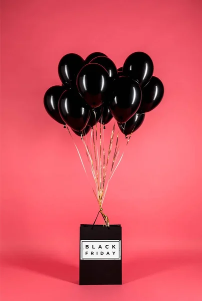 Black balloons and shopping bag — Stock Photo