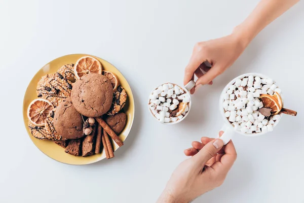 Hands with cacao and cookies — Stock Photo