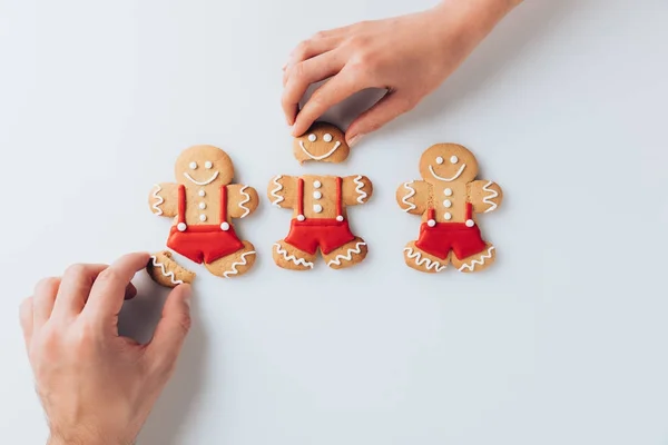 Hands with crashed gingerbreads — Stock Photo