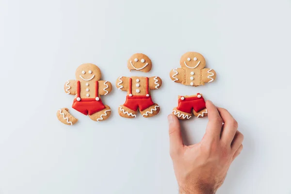 Hand with crashed gingerbread men — Stock Photo