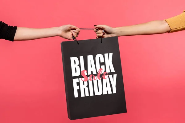 Women pulling shopping bag — Stock Photo