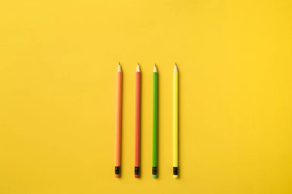 Four colored pencils with erasers — Stock Photo