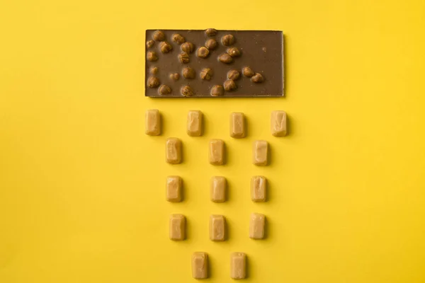 Chocolate bar and iris milk candies — Stock Photo