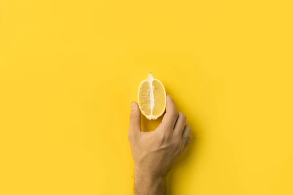 Man holding half of lemon — Stock Photo