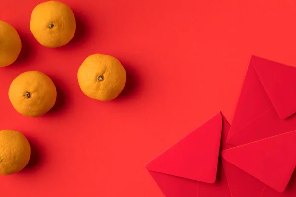 Red envelopes and tangerines — Stock Photo