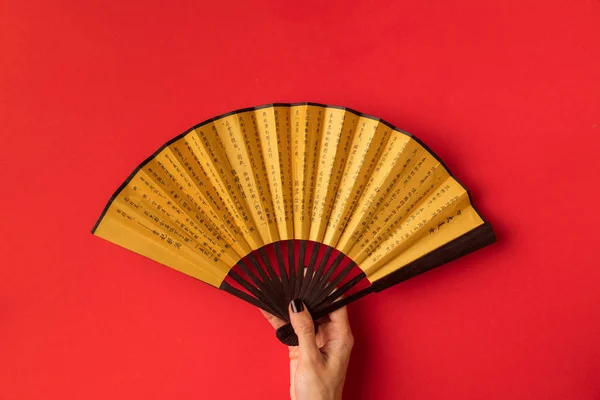 Oriental fan in hand — Stock Photo