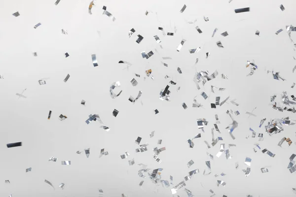Falling silver confetti pieces — Stock Photo