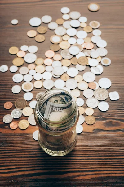 Glass jar with banknotes and coins — Stock Photo