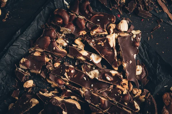 Dark chocolate with nuts pieces — Stock Photo