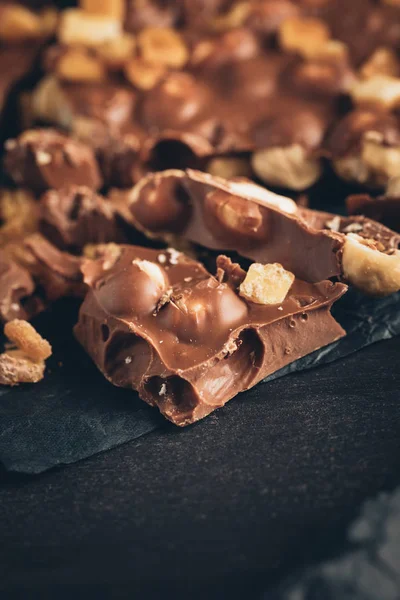 Milk chocolate with nuts pieces — Stock Photo