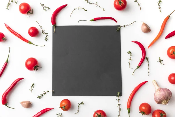 Black board among chili peppers — Stock Photo