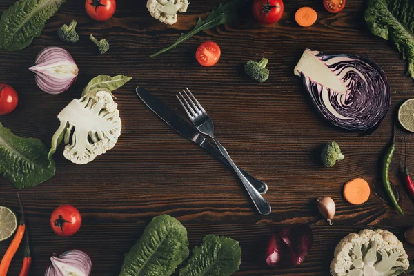 Knife and fork with vegetables — Stock Photo