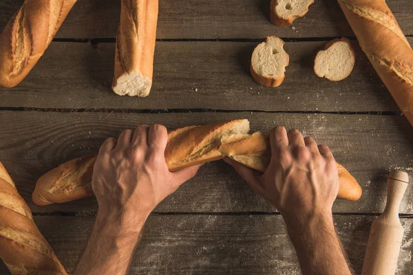 Baguette in hands — Stock Photo