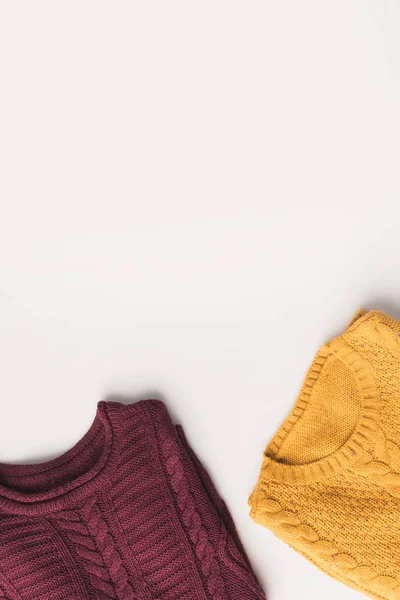 Burgundy and yellow sweaters — Stock Photo