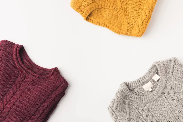 Grey, burgundy and yellow sweaters — Stock Photo