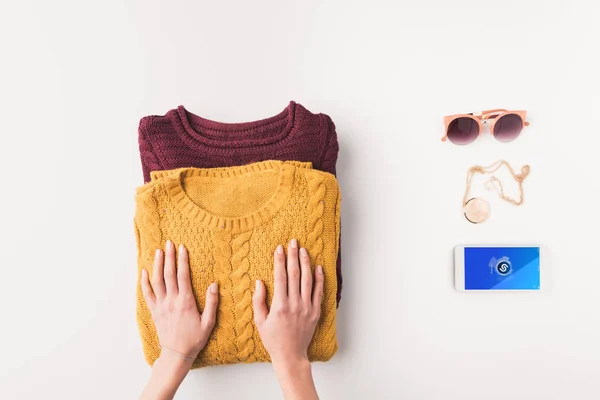 Sweaters and smartphone with shazam appliance — Stock Photo