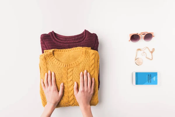 Sweaters and smartphone with skype — Stock Photo