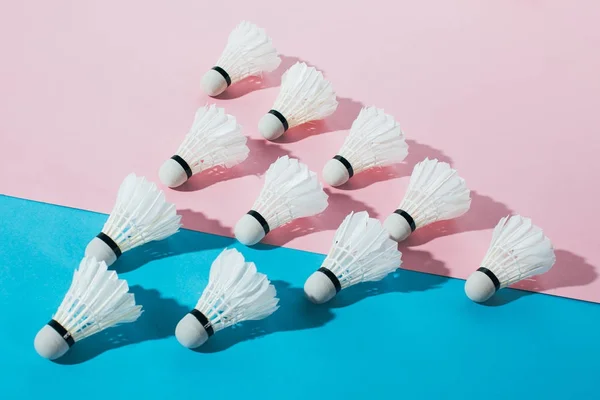 Top view of composition with badminton shuttlecocks on blue and pink — Stock Photo