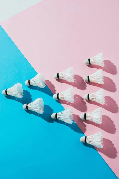 Top view of composition with badminton shuttlecocks on blue and pink — Stock Photo
