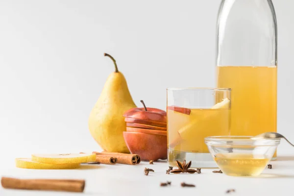 Refreshing cider in bottle with glass and fruits on white surface — Stock Photo