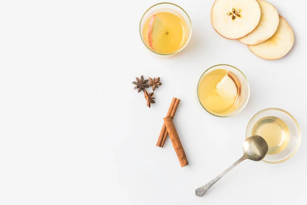 Top view of glasses of apple cider with spices isolated on white — Stock Photo