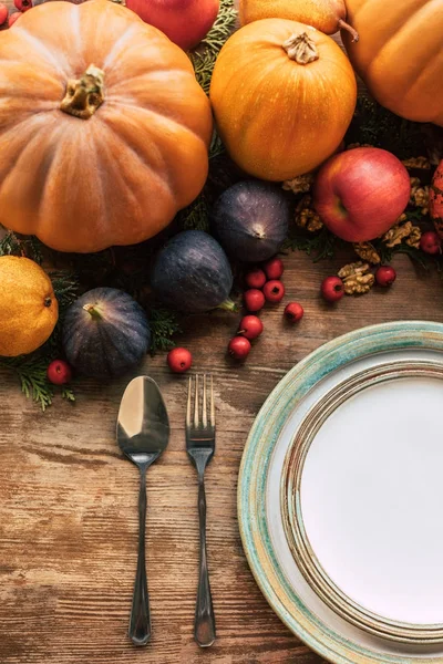 Top view of table setting with various fruits and pumpkins as autumn decor — Stock Photo