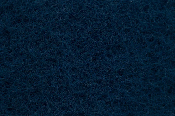 Textura da esponja de cozinha de lavagem azul escuro — Fotografia de Stock