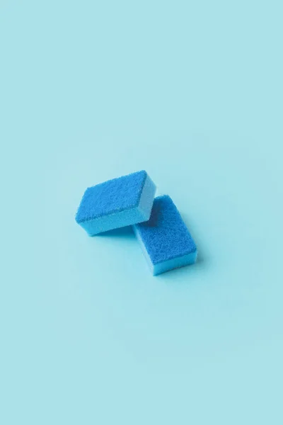 Two blue washing kitchen sponges, on blue — Stock Photo