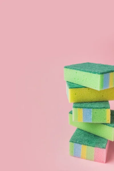 Pile of colorful washing kitchen sponges, on pink — Stock Photo