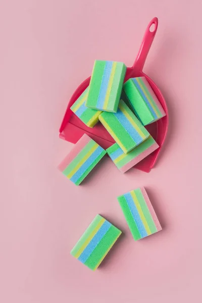 Top view of colorful washing sponges in scoop, isolated on pink — Stock Photo