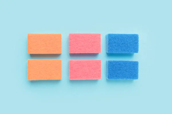 Top view of colorful washing sponges, on blue — Stock Photo