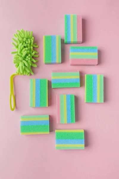 Top view of colorful washing sponges and brush, on pink — Stock Photo