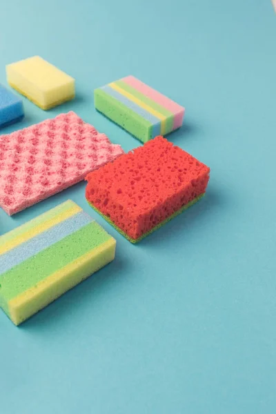 Studio shot of different washing kitchen sponges, on blue — Stock Photo
