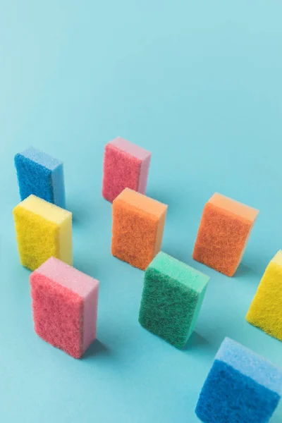 Estúdio tiro de esponjas de cozinha de lavagem coloridas, em azul com espaço de cópia — Fotografia de Stock