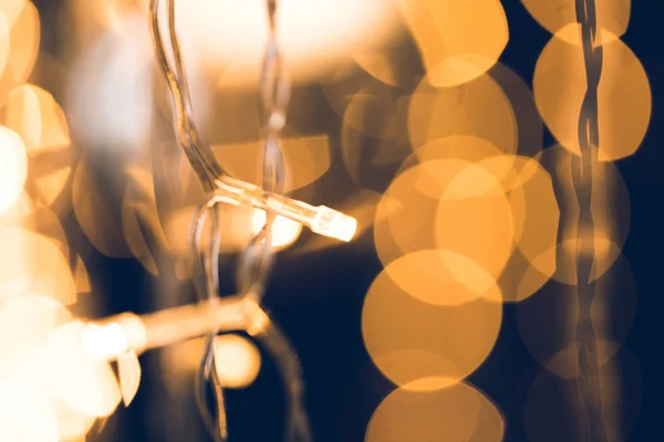 Close-up shot of beautiful golden garland on black background — Stock Photo