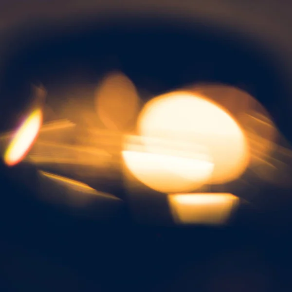 Blurred abstract golden fugures on black background — Stock Photo